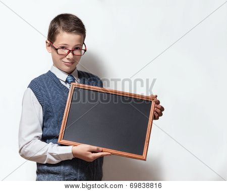 Schoolboy in glasses with with empty chalkboard
