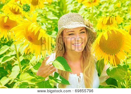 Portrait of cute girl in beautiful fresh sunflower field, geat yellow flowers, enjoying European nature, Italy, Tuscany, summertime vacation concept 