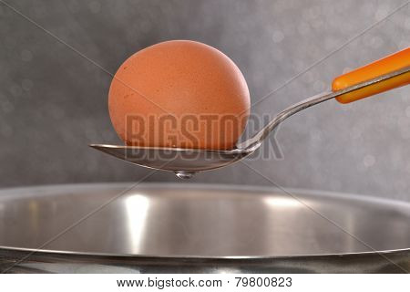 Boiling egg on a pan.