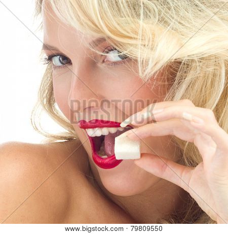 portrait of attractive  caucasian smiling woman isolated on white studio shot eating sugar