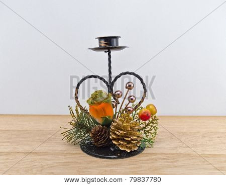 Heart-shaped  iron support  for pillar candle against white background