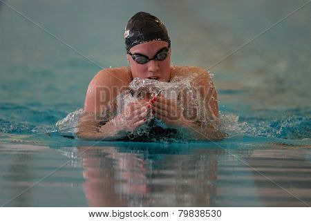 GRAZ, AUSTRIA - APRIL 04, 2014: Teja Kozelj (Slovenia) places 10th in the women's 100m breaststroke event in an indoor swimming meeting.