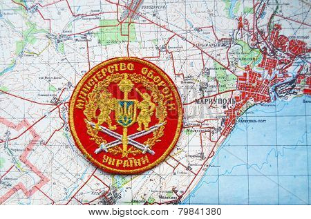 Kiev,Ukraine.JAN 10.Illustrative editorial.Ukrainian Department of Defense chevron .With map of Mariupol. City and port on Azov Sea.At present time frontline. At January 10,2015 in Kiev, Ukraine 