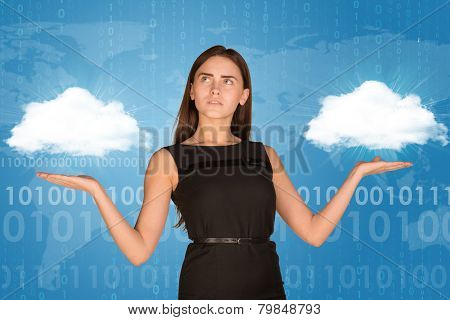 Businesswoman holding two white clouds, as if chosing