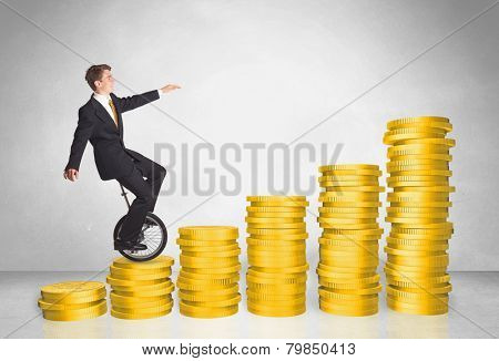 Business man riding monocycle up on coin graph concept on background