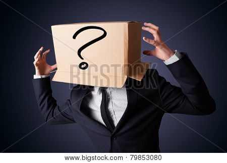 Businessman standing and gesturing with a cardboard box on his head with question mark