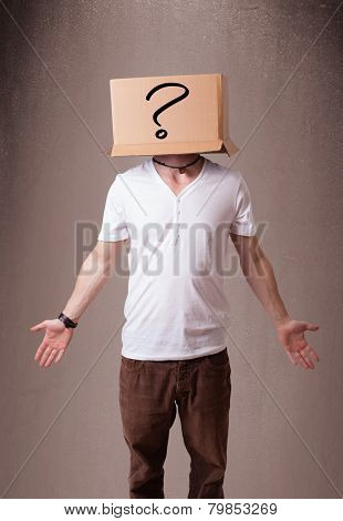 Young man standing and gesturing with a cardboard box on his head with question mark