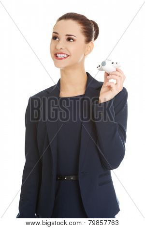 Young businesswoman with plane toy in hand