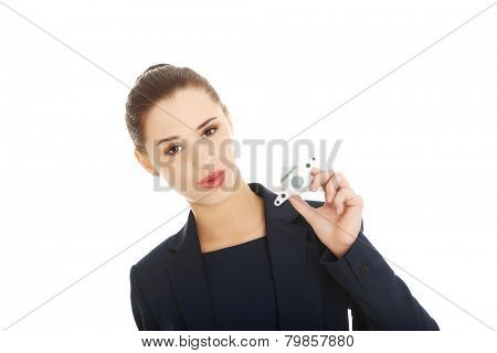 Young businesswoman with plane toy in hand