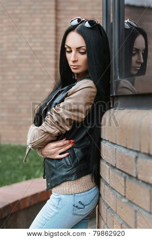 Girl In A Leather Jacket Standing Near The Building