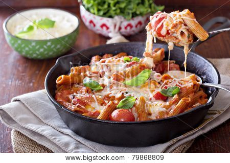 Pasta bake with penne, tomatoes and mozarella