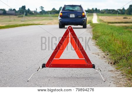 Red Warning Triangle With A Broken Down Car