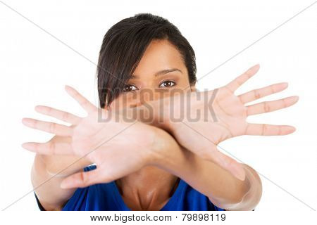Young mulato woman making stop sign.