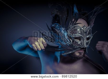 Carnival, bearded man with silver mask Venetian style. Mystery and renaissance