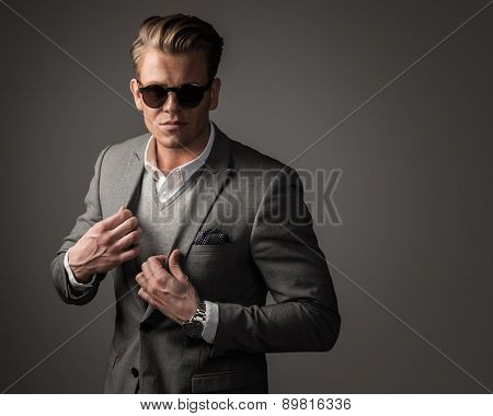 Confident sharp dressed man in black suit 