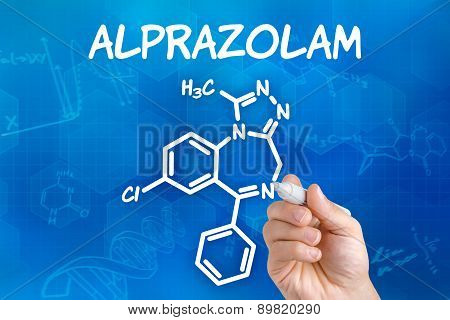 Hand With Pen Drawing The Chemical Formula Of Alprazolam
