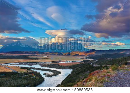 Mad wind over Patagonia. Striking clouds over the rocks  Los Kuernos and Valley Serrano