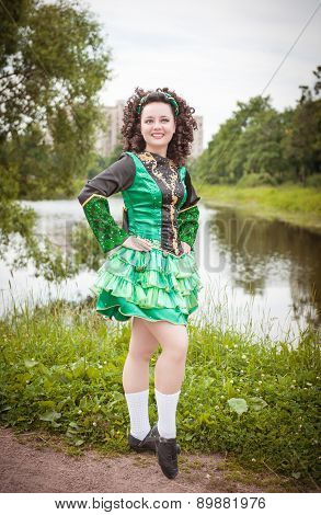 Young Beautiful Girl In Irish Dance Dress And Wig Posing