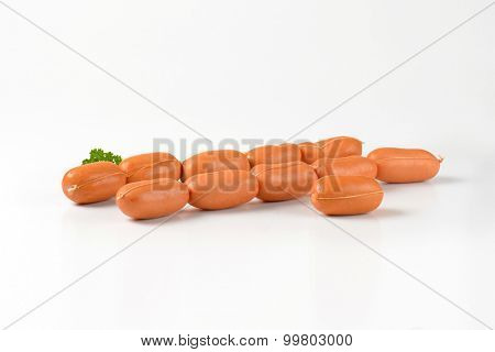 chains of raw sausages on white background