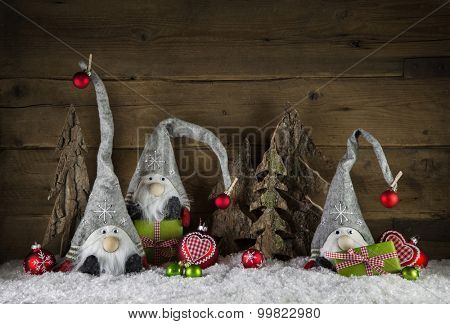 Rustic christmas decoration in country style with gnom like santa on old wooden background with green gifts.