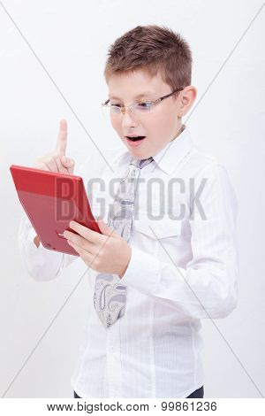 Portrait of teen boy with calculator on white background