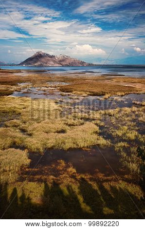 Mountains as a backdrop , reflecting in the waters of the lake
