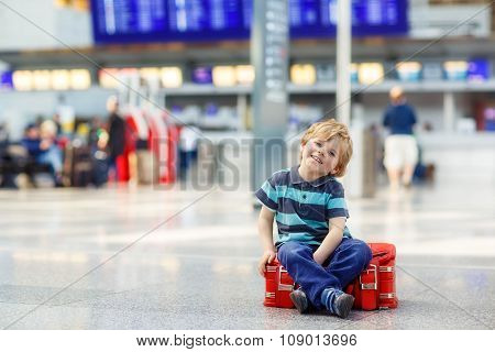 little tired kid boy at the airport, traveling