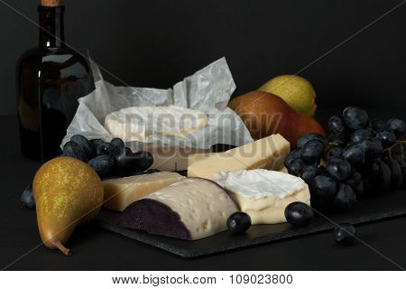 Assorted Cheese On Slate Stone. Grapes, Pears