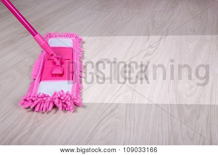 Cleaning Concept - Wet Mop On Wooden Floor With Word Cleaning