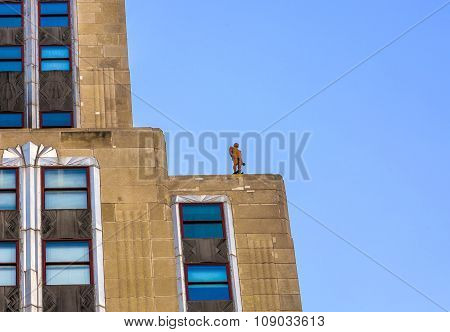 Facade Of Skyscraper With Statue Of Man