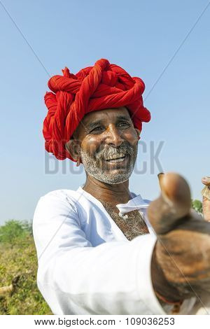 A Rajasthani Tribal Man Wearing Traditional Colorful Turban And Loves To Pose