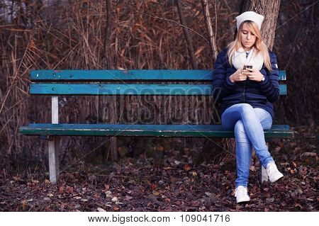 Young woman sitting on bench with her best friend