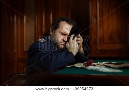 Man Sitting At The Table Crying.