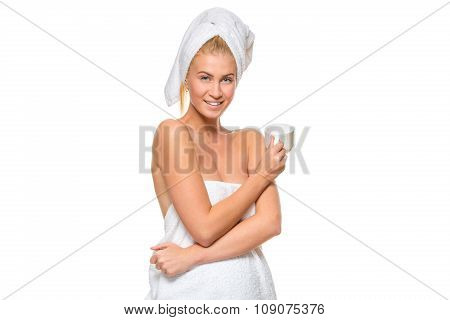 Young attractive woman in towel holding a cup