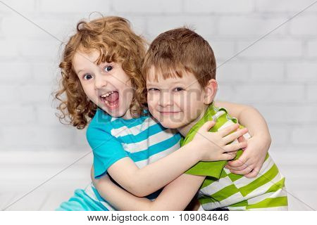 Happy Brother And Sister Smiling And Embracing.