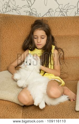 Sad little girl hugging her toy.