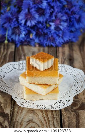 Cottage cheese baked pudding, selective focus, with fowers background
