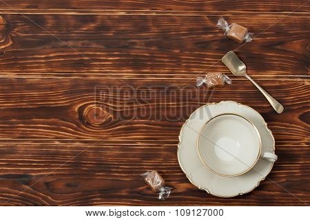 Empty Cup and Plate Of Fine Bone China. Sweets. Burnt Wooden Bac