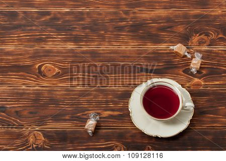 Tea Cup and Plate Of Fine Bone China. Sweets. Burnt Wooden Backg