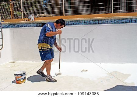 A man painting redone the pool