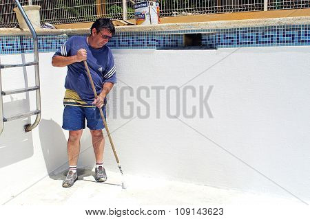 A man painting redone the pool