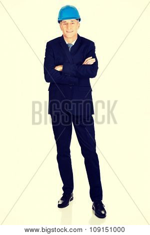 Mature confident businessma with a helmet.