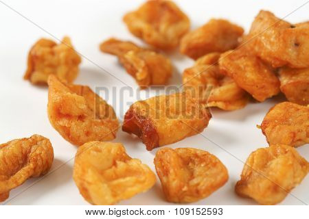 detail of pork greaves on white background