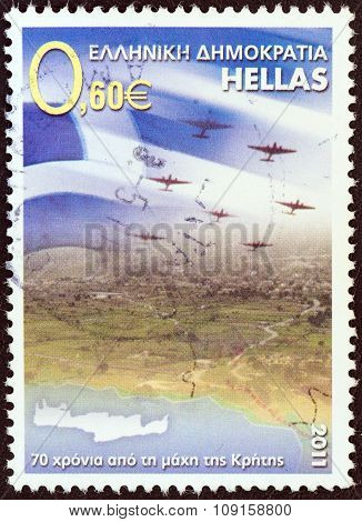 GREECE - CIRCA 2011: A stamp printed in Greece issued for the 70th anniversary of the Battle of Crete shows Greek flag and airplanes over Crete, circa 2011.