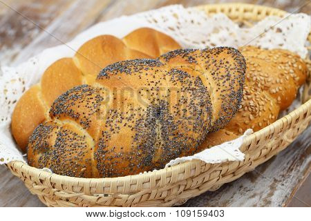 Challah bread with poppy seeds, sesame seeds and plain in bread basket