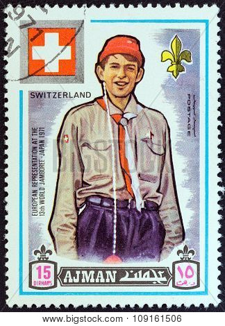 AJMAN EMIRATE - CIRCA 1971: A stamp printed in United Arab Emirates shows boy scout from Switzerland