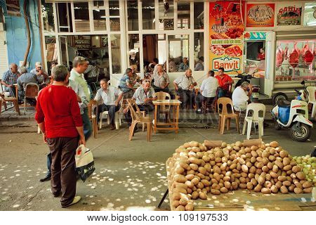 Many Men Drinking Tea And Talking In Tea Garden Near The Vegetable Market Of Sirince Village