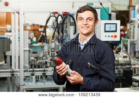 Apprentice Engineer Checking Component In Factory