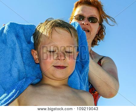 Mother Towels Boy At The Beach With Towel