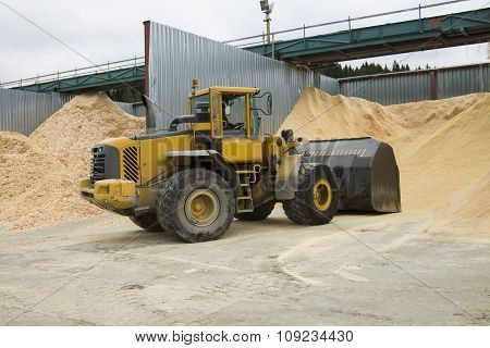 Front End Loader Working In Sawdust Storage Area